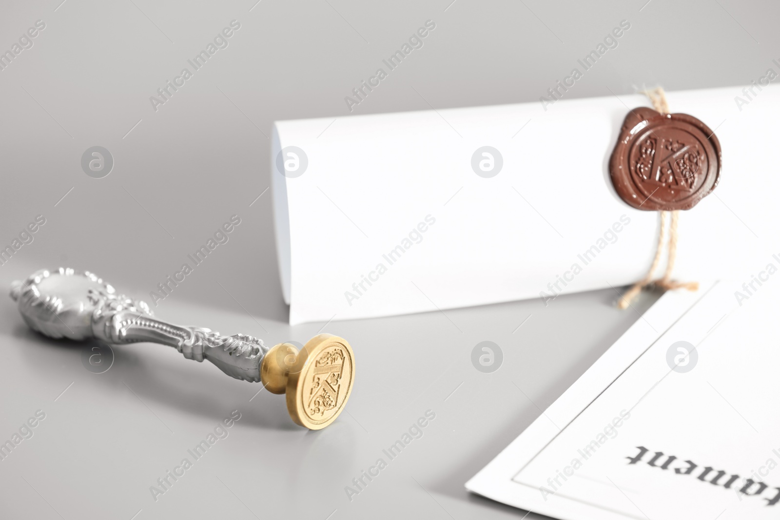 Photo of Vintage notary stamp and documents on grey background, closeup