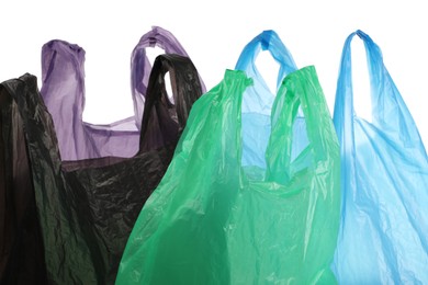 Photo of Many different plastic bags on white background