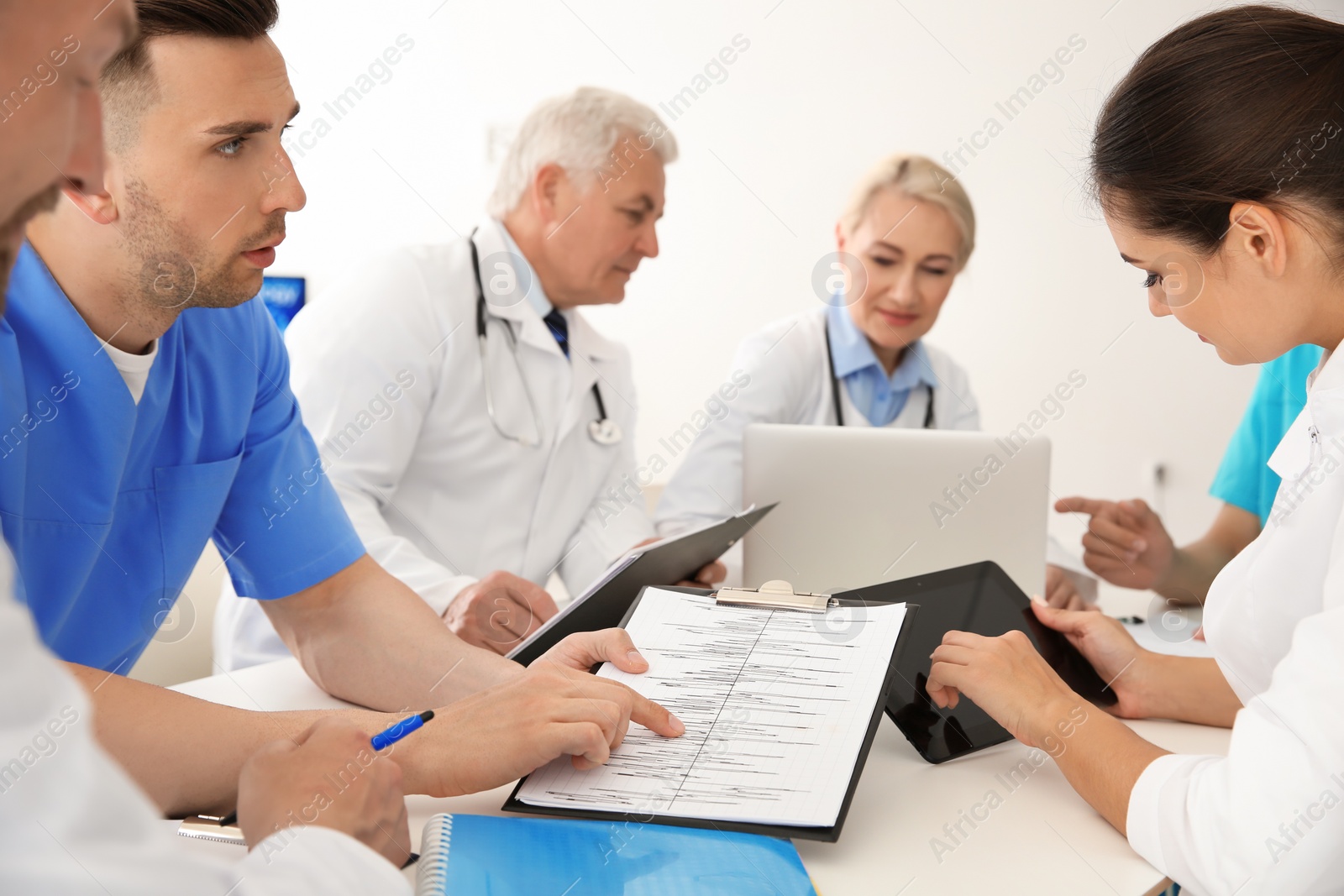 Photo of Group of doctors attending meeting in clinic. Cardiology conference