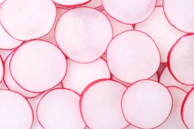 Photo of Slices of fresh ripe radish as background, top view