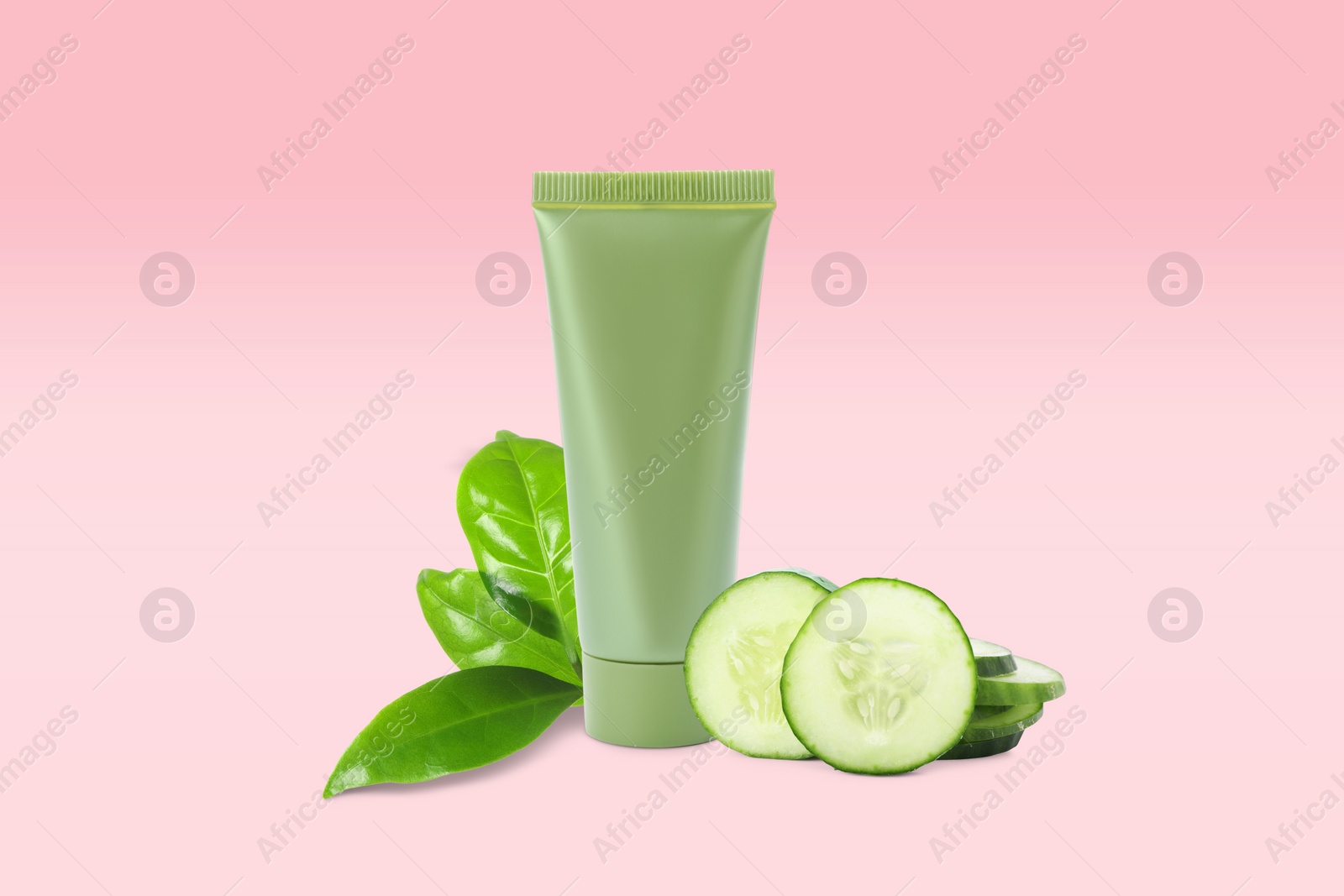 Image of Makeup remover, fresh cucumber and green leaves on pink background