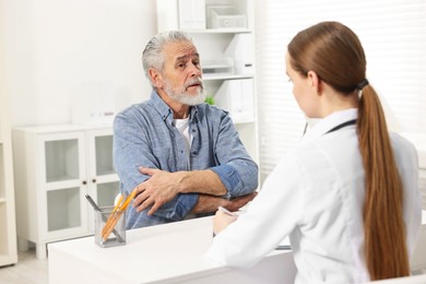 Arthritis symptoms. Doctor consulting patient with elbow pain in hospital