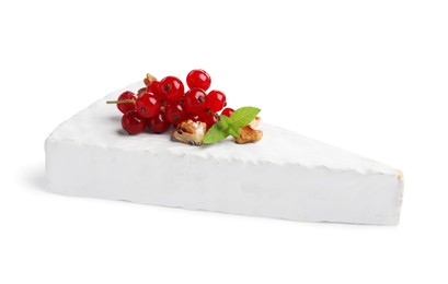 Photo of Brie cheese served with red currants and walnuts isolated on white