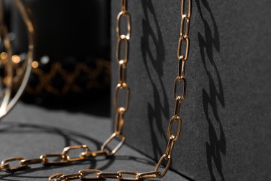 Photo of Metal chain on black table, closeup. Luxury jewelry