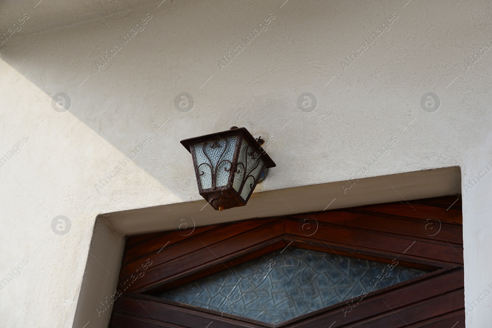 Photo of Vintage lamp on white wall of building