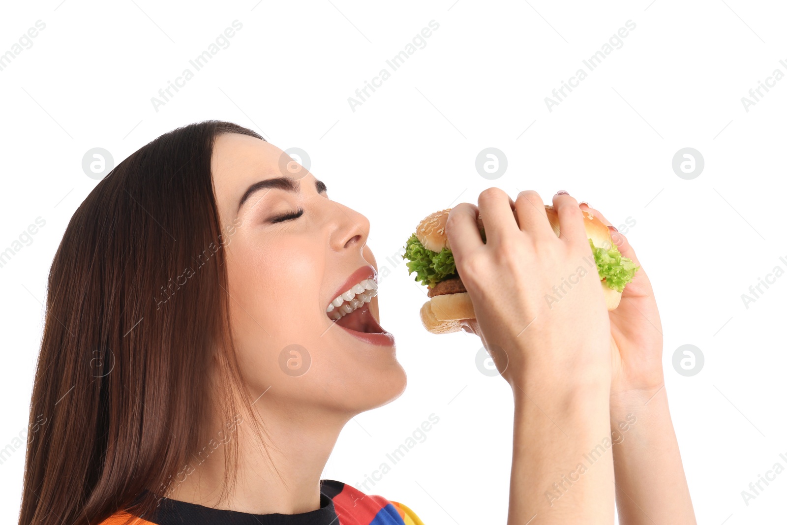 Photo of Young woman eating tasty burger on white background