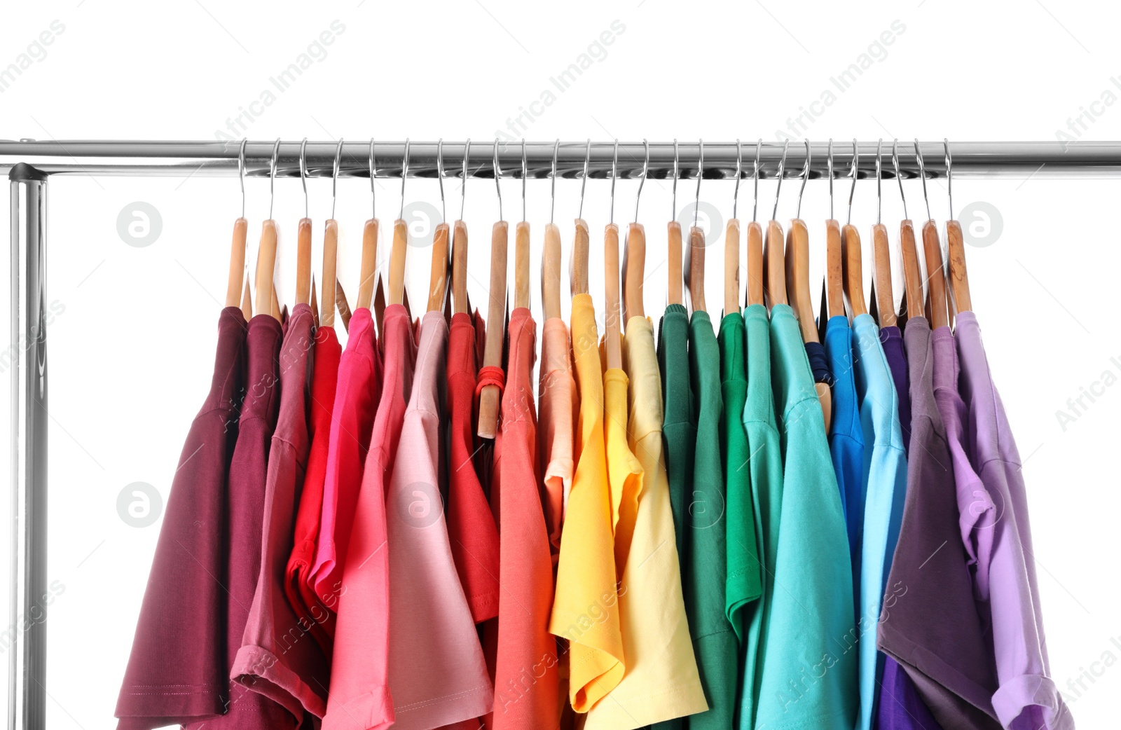 Photo of Rack with rainbow clothes on light background