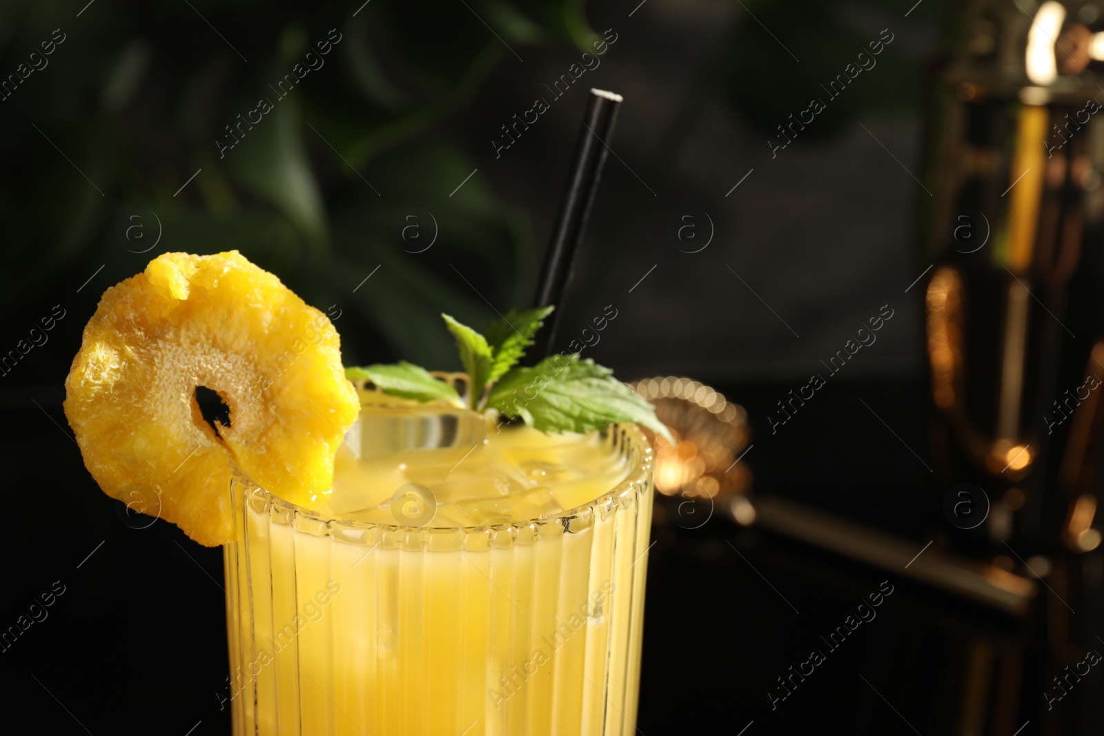 Photo of Tasty pineapple cocktail with mint in glass, closeup. Space for text