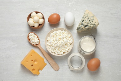 Photo of Different dairy products on white table, flat lay