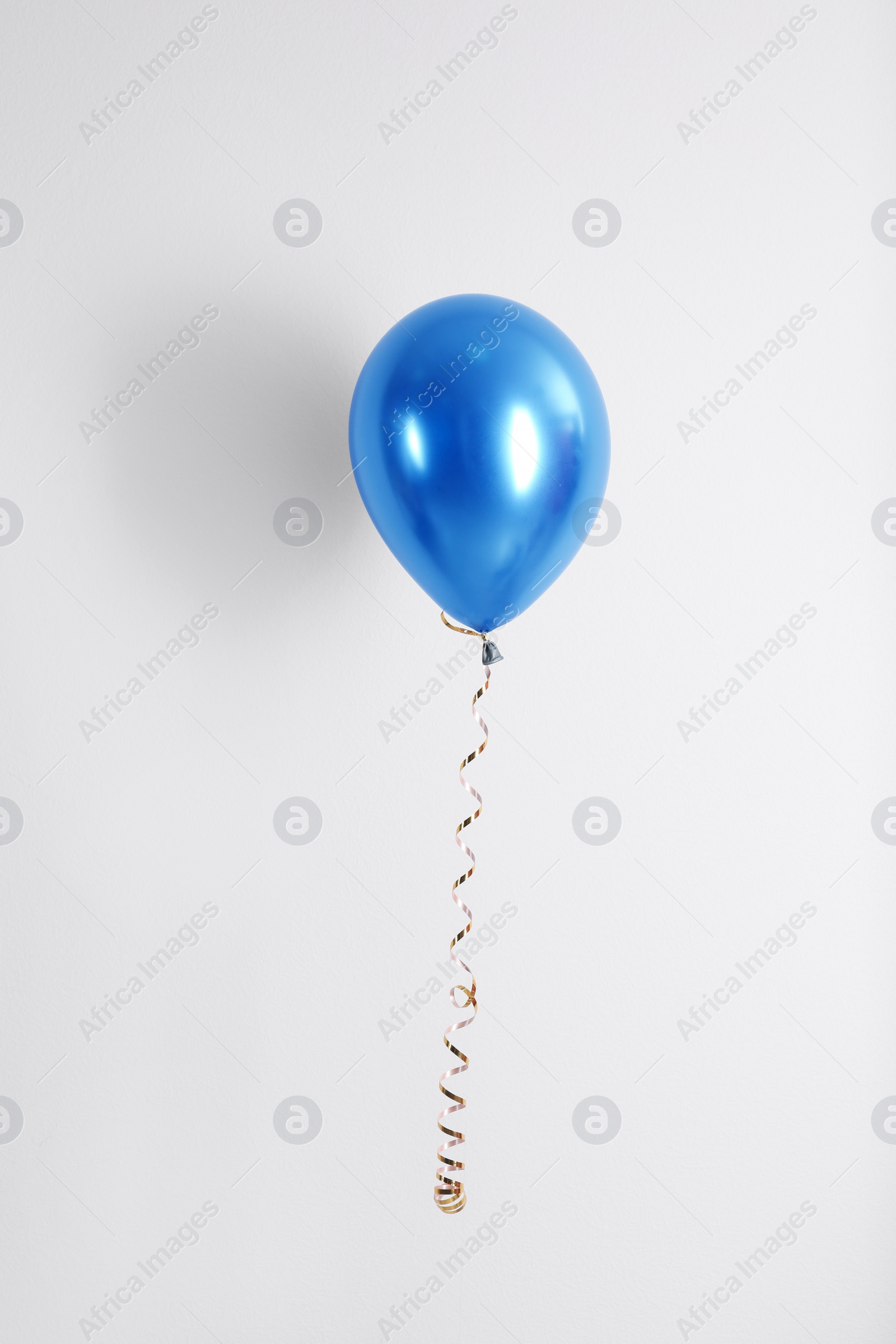 Photo of Color balloon with ribbon on white background