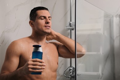 Photo of Man using gel in shower at home