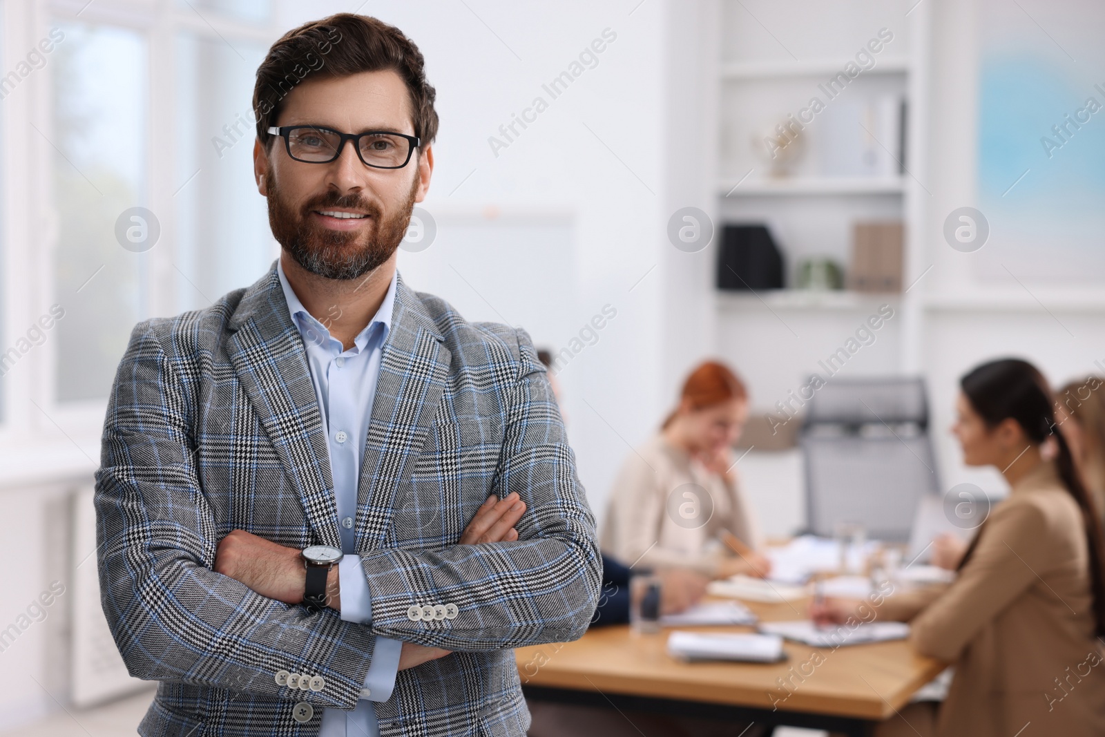 Photo of Team of employees working together in office. Stylish businessman indoors