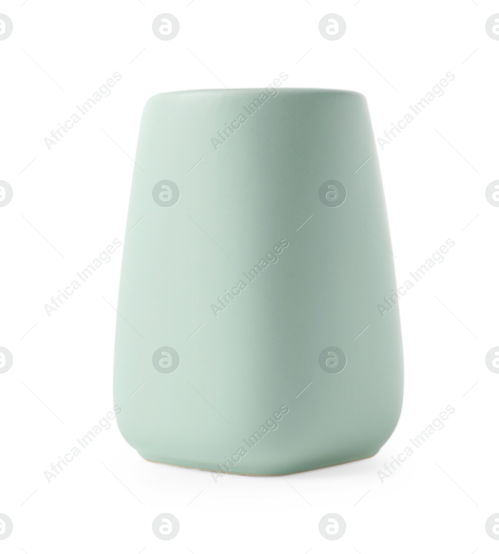 Photo of Bath accessory. Light green ceramic toothbrush holder isolated on white