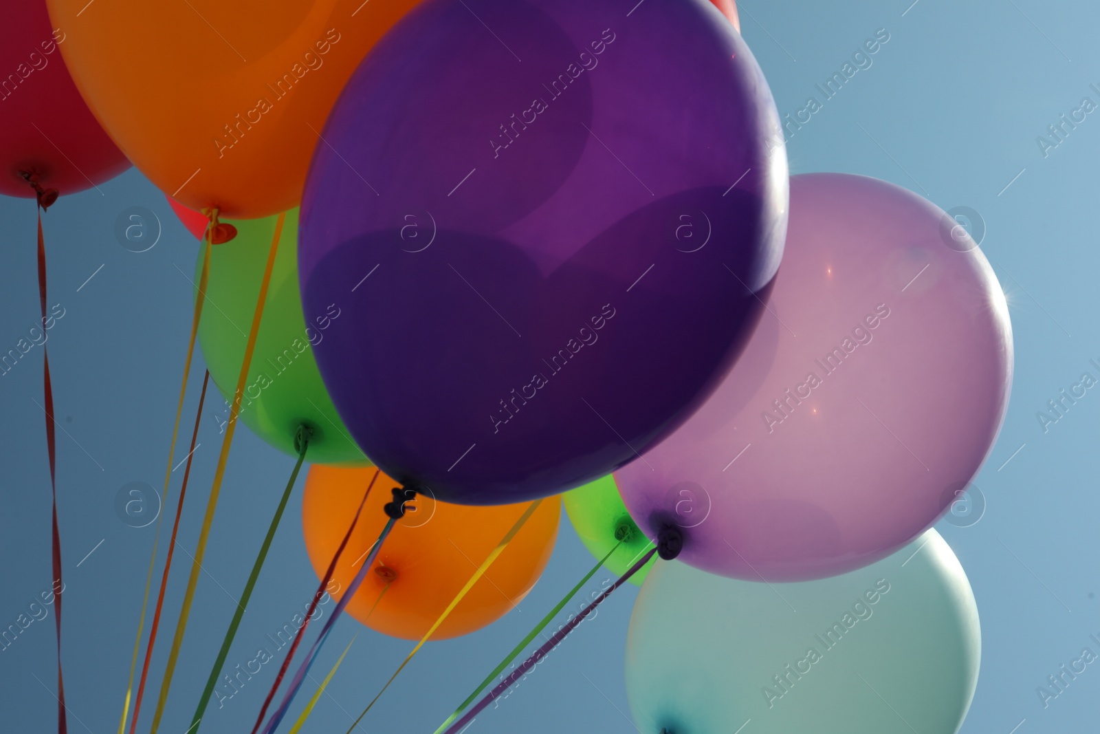 Photo of Bunch of colorful balloons against blue sky