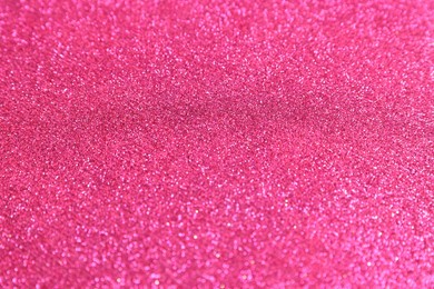 Photo of Beautiful pink shiny glitter as background, top view