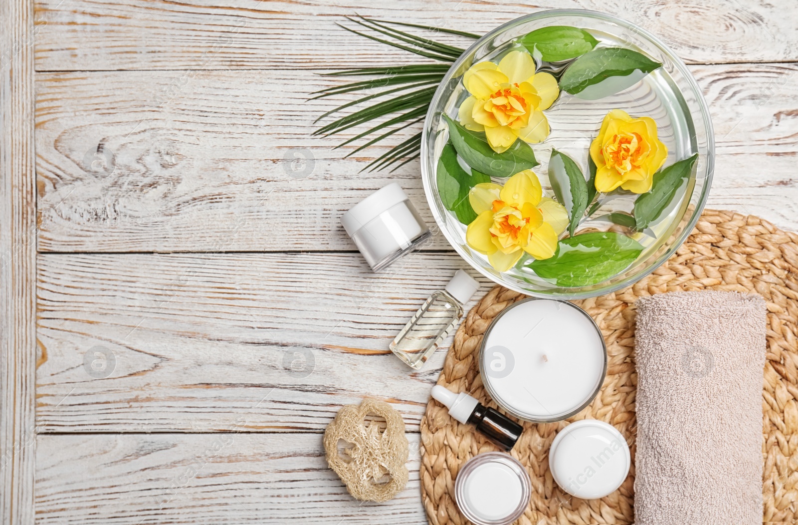 Photo of Composition with spa accessories and flowers on wooden background