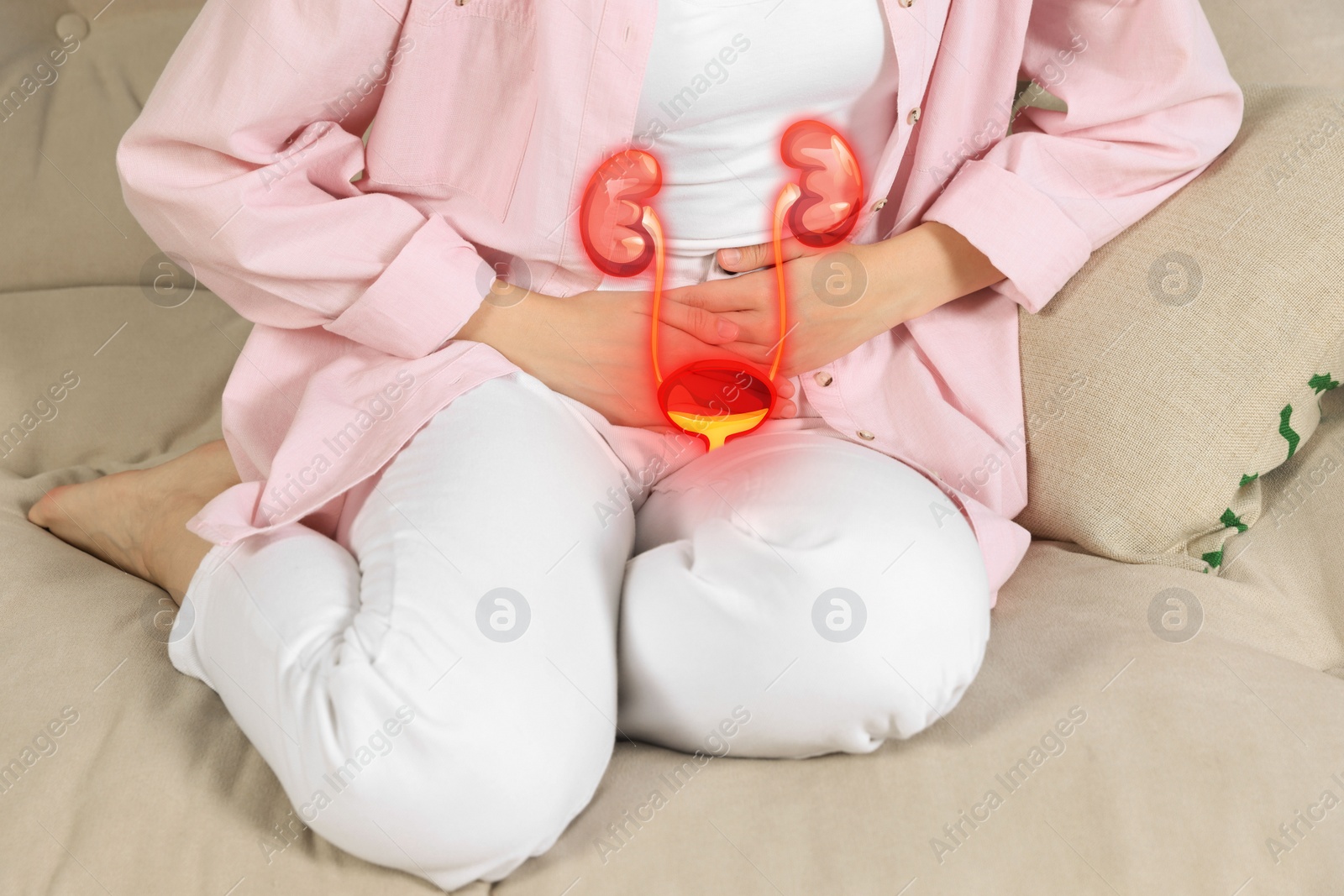 Image of Woman suffering from cystitis on sofa at home, closeup. Illustration of urinary system