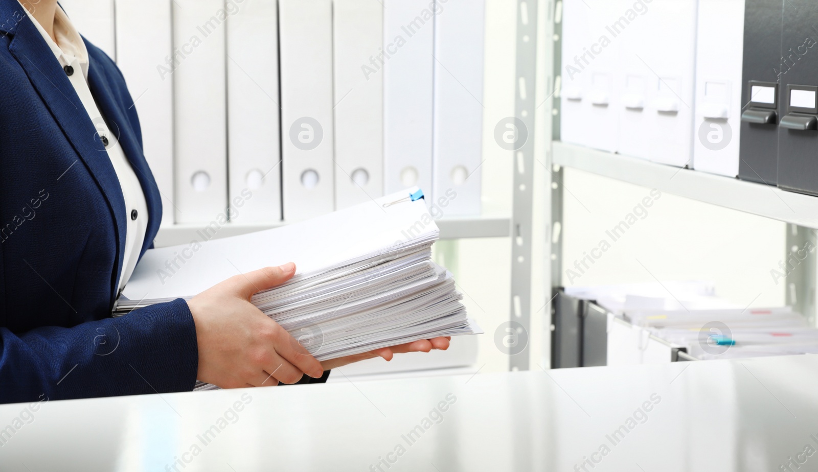 Photo of Female worker with documents in office, closeup. Space for text