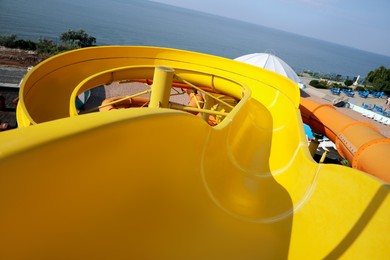 Yellow slide in water park on sunny day