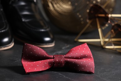 Photo of Stylish red bow tie on black background