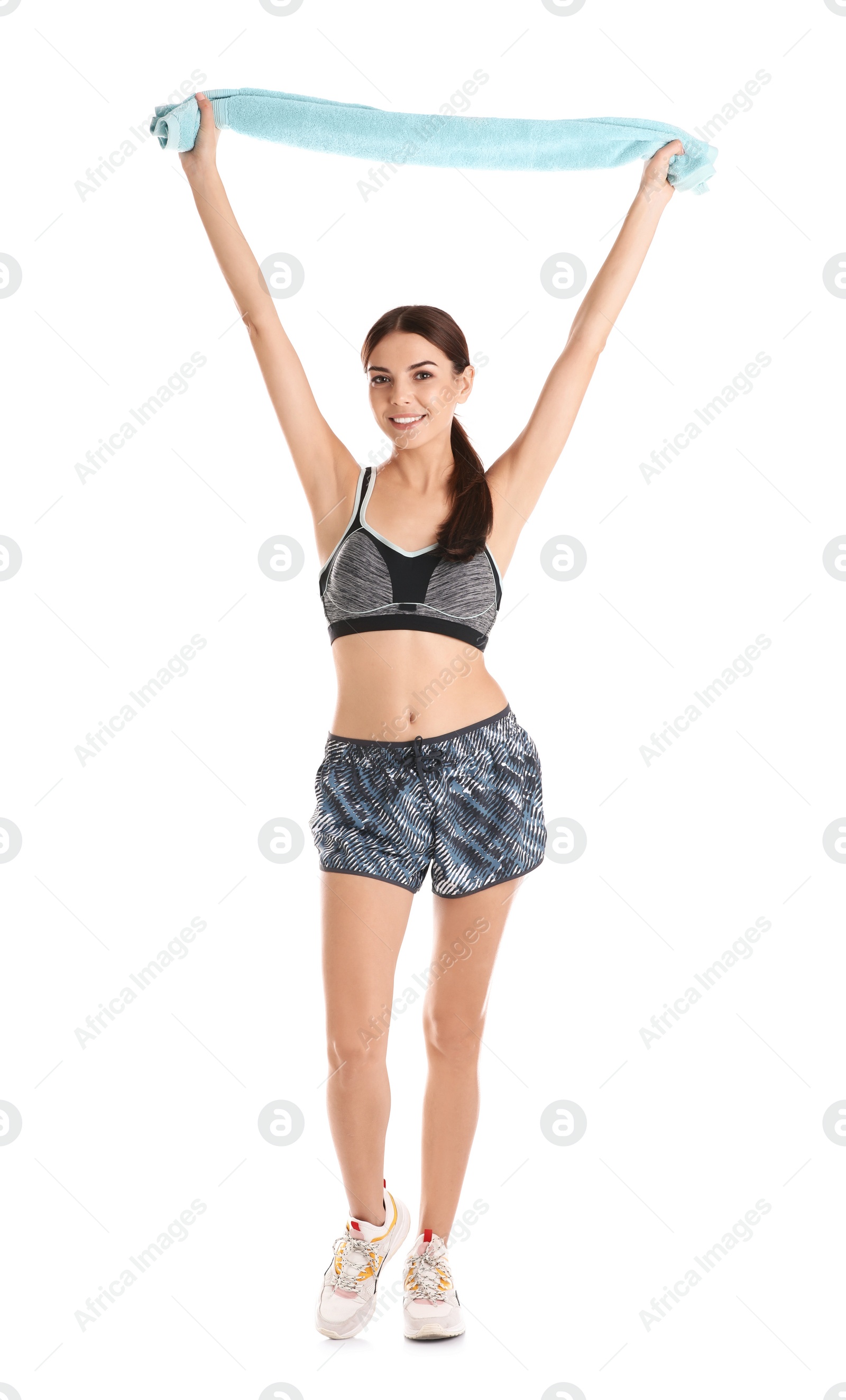 Photo of Beautiful young woman in sportswear with towel on white background