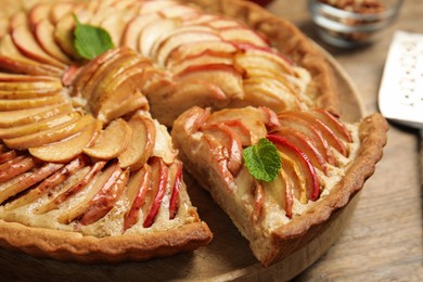 Photo of Delicious apple pie on wooden table, closeup
