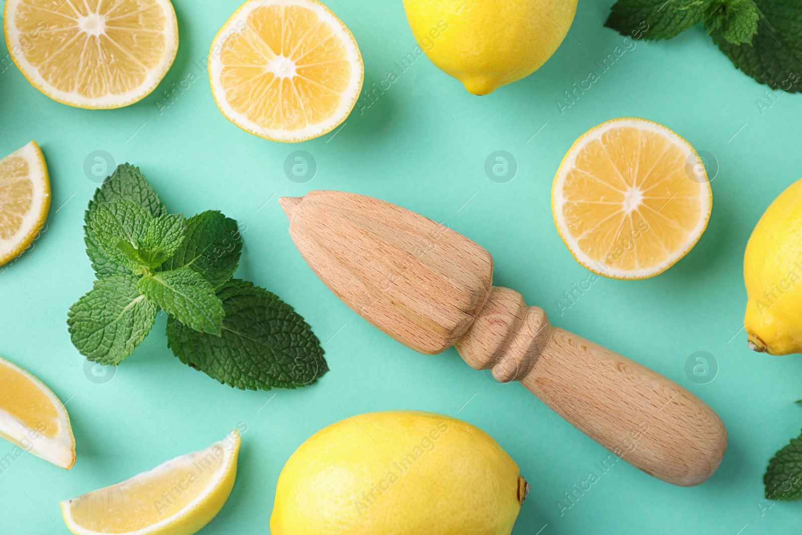 Photo of Flat lay composition with fresh lemons on turquoise background