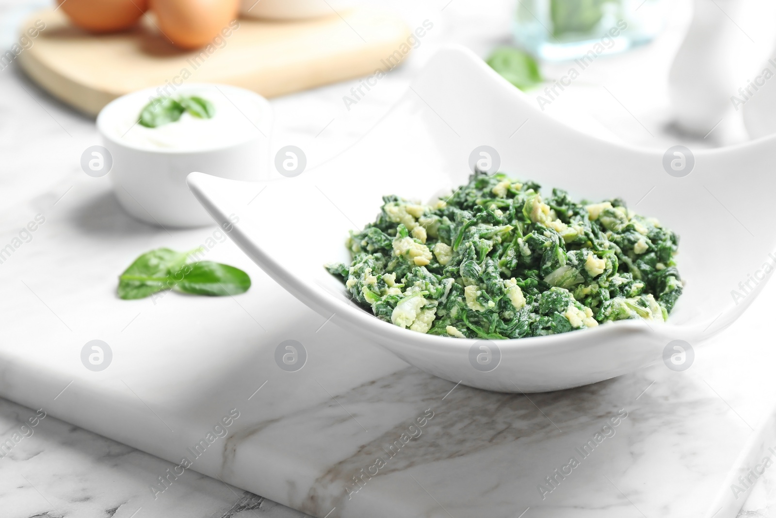 Photo of Plate with tasty cooked spinach on table. Healthy food