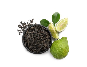 Photo of Dry bergamot tea leaves and fresh fruits on white background, top view