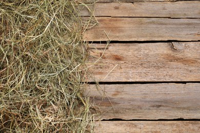 Photo of Dried hay on wooden table, top view. Space for text