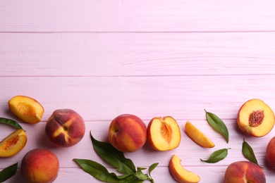 Photo of Fresh sweet peaches on pink wooden table, flat lay. Space for text
