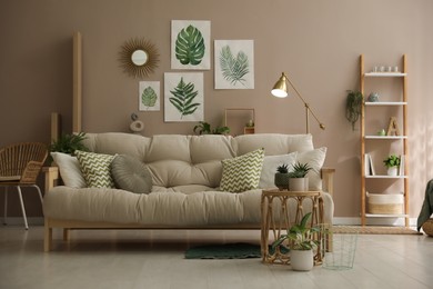 Photo of Stylish living room interior with comfortable sofa and beautiful pictures on wall