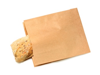 Paper bag with bread on white background, top view. Space for design