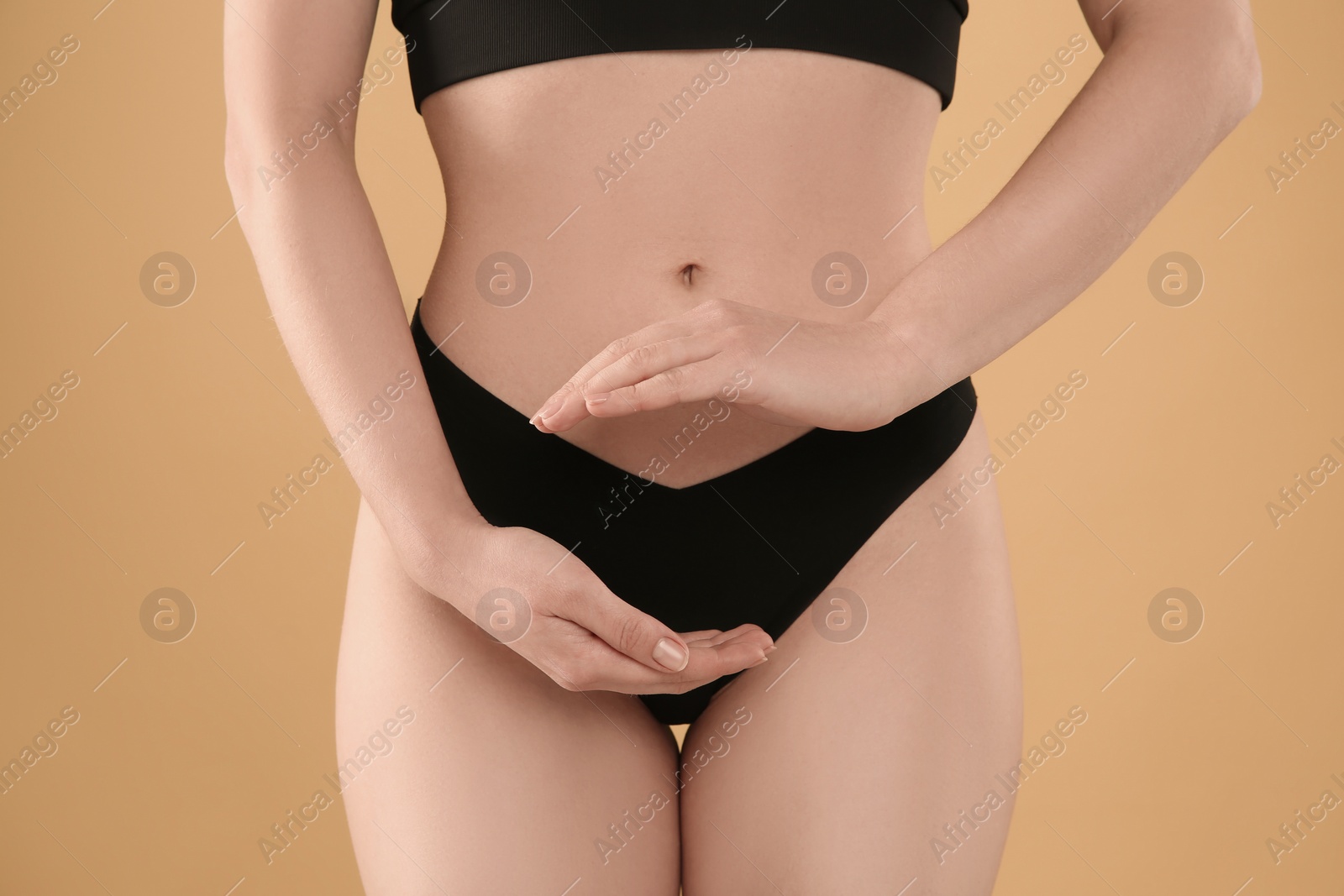 Photo of Gynecology. Woman in underwear on yellow background, closeup