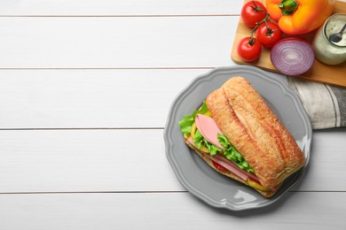 Photo of Tasty sandwich with boiled sausage, cheese and vegetables on white wooden table, flat lay. Space for text