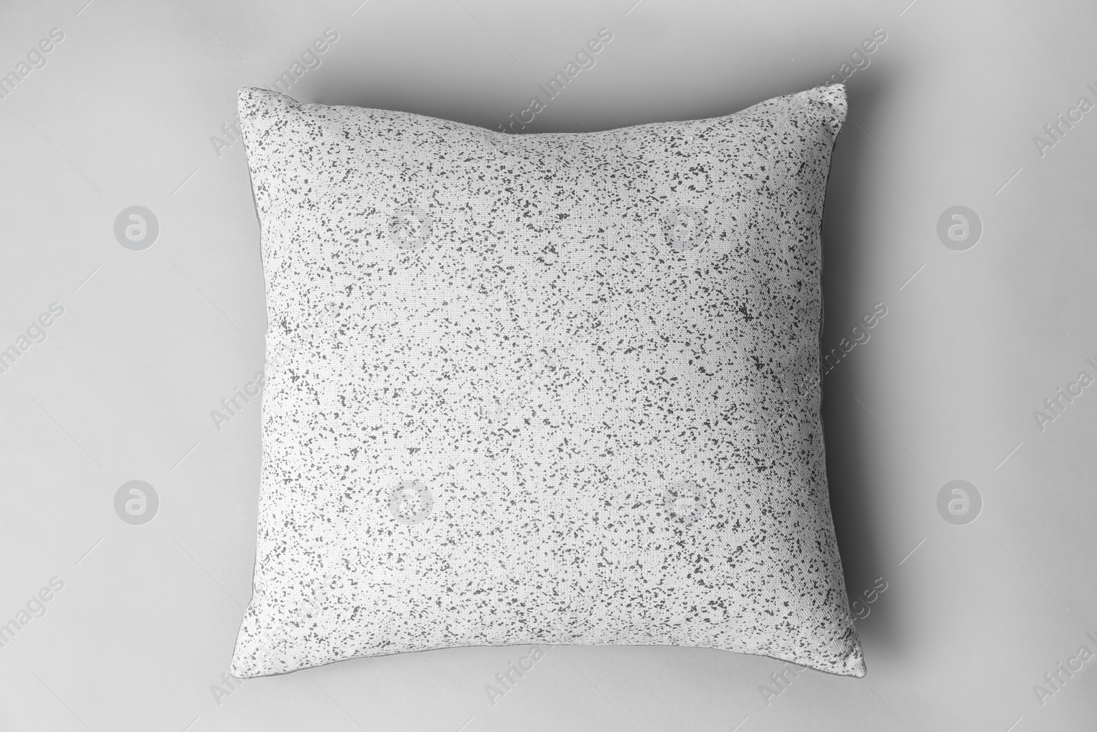 Photo of Soft decorative pillow on light background