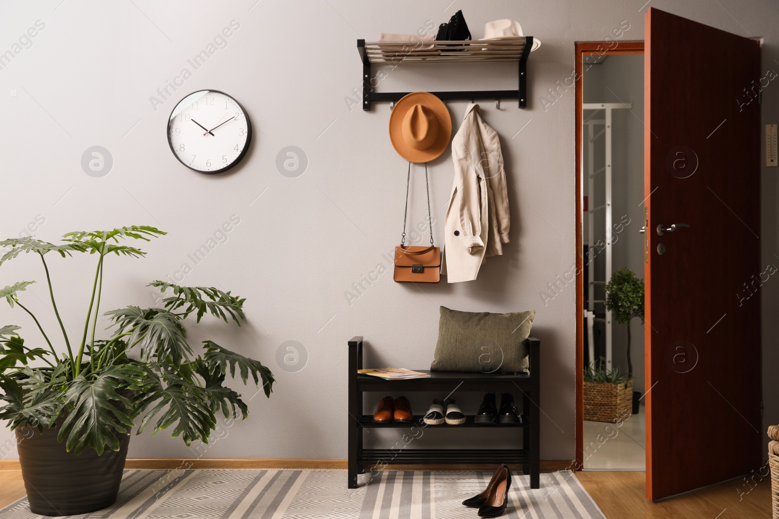 Photo of Hallway interior with stylish furniture, clothes and accessories