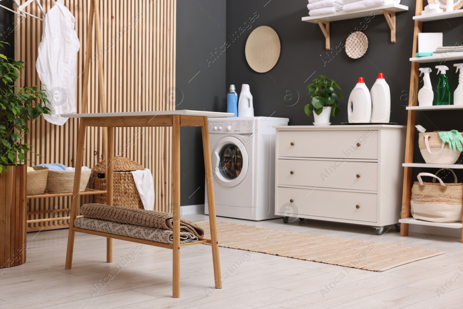 Photo of Laundry room interior with washing machine and furniture