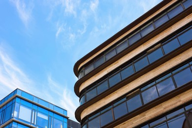 Low angle view of modern buildings against blue sky