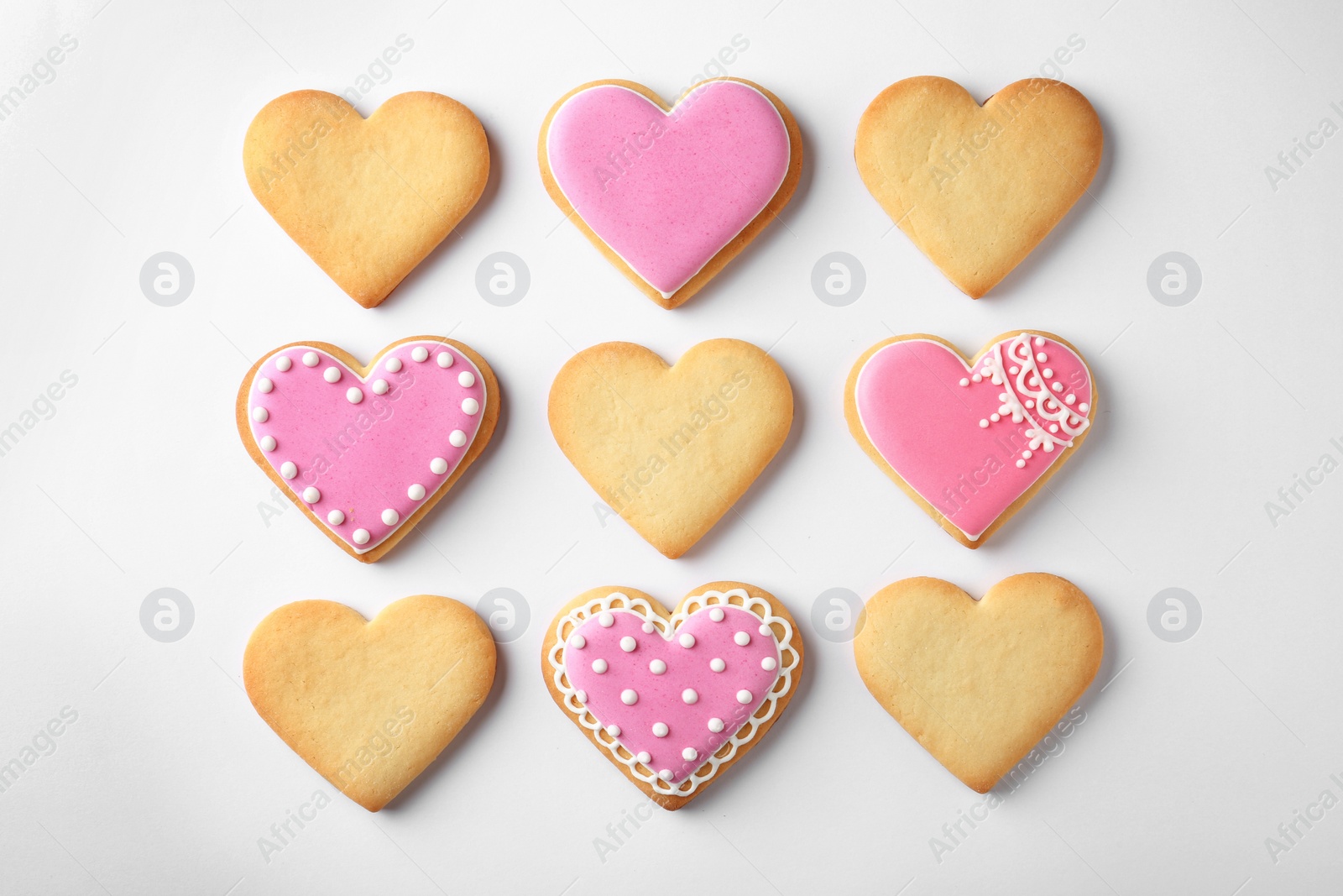 Photo of Decorated heart shaped cookies on white background, top view