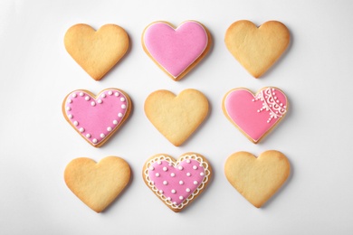 Decorated heart shaped cookies on white background, top view