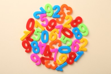 Photo of Colorful numbers on beige background, top view