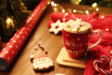 Photo of Tasty hot drink in cup with inscription Believe in Magic, space for text. Christmas atmosphere