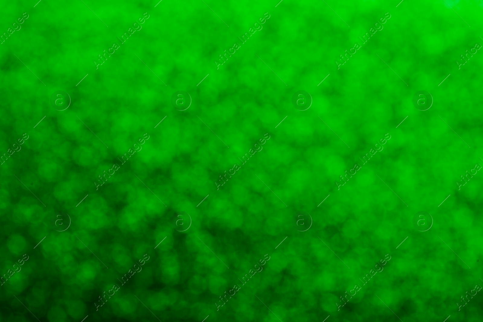 Image of St. Patrick day. Green glitter as background, blurred view. Bokeh effect