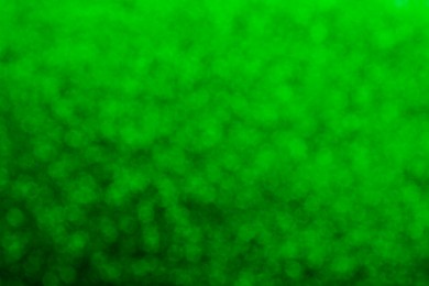 Image of St. Patrick day. Green glitter as background, blurred view. Bokeh effect