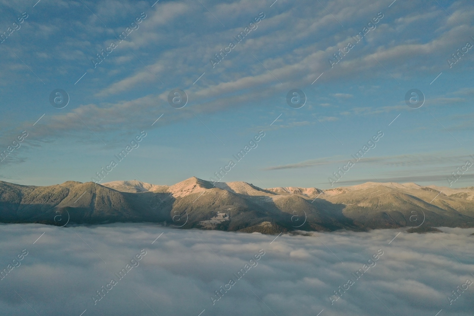 Photo of Aerial view of beautiful mountains above clouds