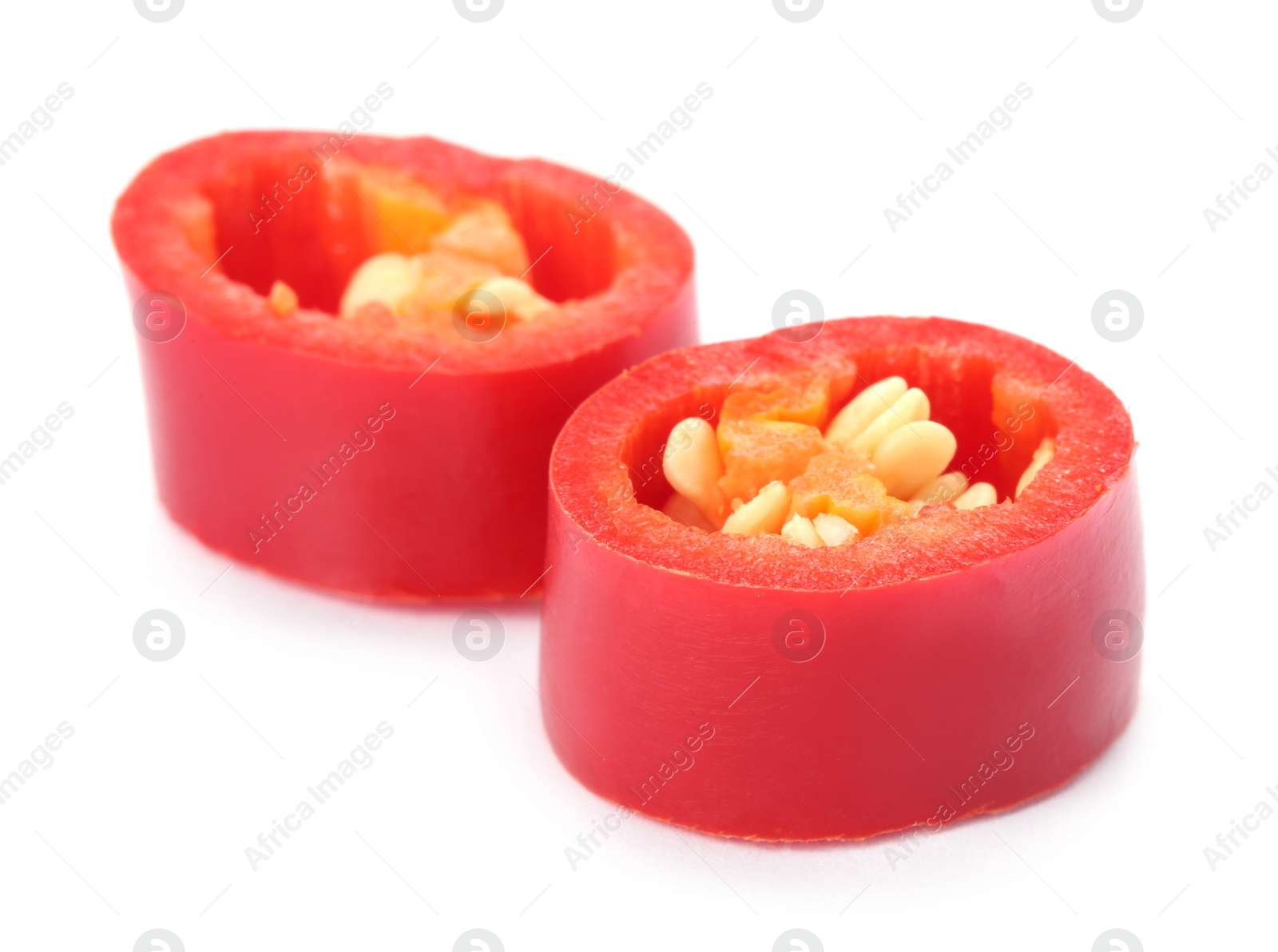 Photo of Slices of red chili pepper on white background