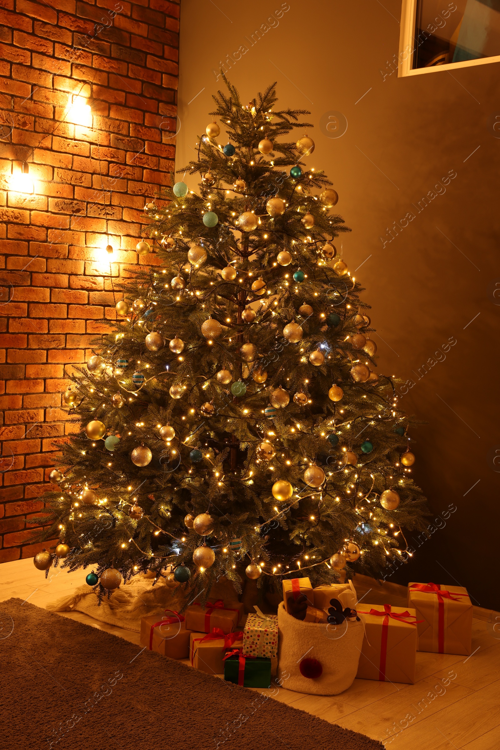 Photo of Beautiful Christmas tree with festive lights and gifts in living room. Interior design