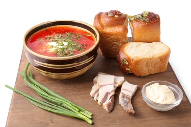 Photo of Delicious borsch served with pampushky, green onions and salo on white background. Traditional Ukrainian cuisine