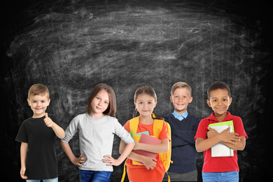 Image of Group of cute school children and chalkboard on background